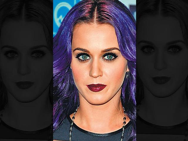 Singer Katy Perry goes for a dramatic look. She teams her plum lips with thickly-lined eyes. Her purple hair goes well with the statement look.