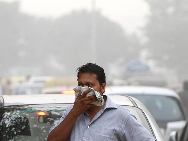 A-man-covers-his-face-on-a-smoggy-day-at-Connaught-Place-in-New-Delhi-Mohd-Zakir-HT-File-Photo