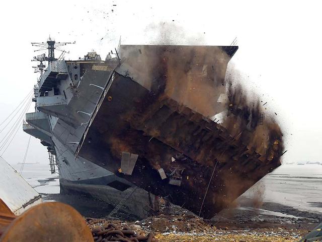 Workers dismantle India's first aircraft carrier INS Vikrant at a ship-breaking yard in Mumbai. (PTI photo)