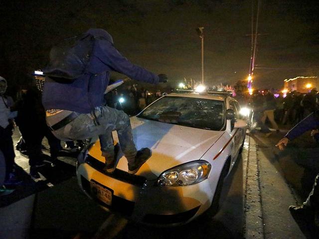 Protesters vandalize a car outside the Ferguson police department in Ferguson, Missouri. (Reuters Photo)