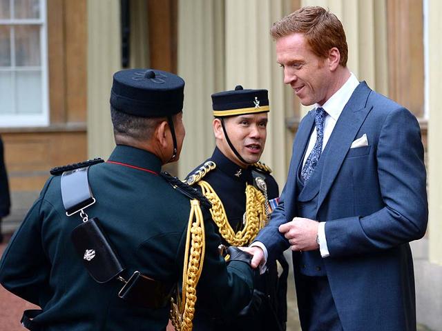 British actor Damian Lewis (R) is congratulated by Gurkha soldiers after recieving his Officer of the Order of the British Empire (OBE) medal. The Homeland star has been awarded for service to drama. (AFP) British actor Damian Lewis (R) is congratulated by Gurkha soldiers after recieving his Officer of the Order of the British Empire (OBE) medal. The Homeland star has been awarded for service to drama. (AFP)