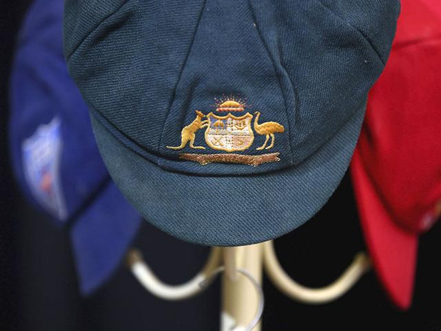 The Baggy Green cap of Phillip Hughes and his state cricket caps on a hat rack inside the Macksville High School Stadium during the funeral of Phillip Hughes in Macksville, Wednesday. (AP Photo) The Baggy Green cap of Phillip Hughes and his state cricket caps on a hat rack inside the Macksville High School Stadium during the funeral of Phillip Hughes in Macksville, Wednesday. (AP Photo)