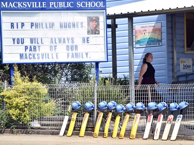 Cricket bats and helmets are lined up outside Macksville Public School hours before the funeral of Australian batsman Phillip Hughes in his home town Macksville on Wednesday. (AFP Photo) Cricket bats and helmets are lined up outside Macksville Public School hours before the funeral of Australian batsman Phillip Hughes in his home town Macksville on Wednesday. (AFP Photo)