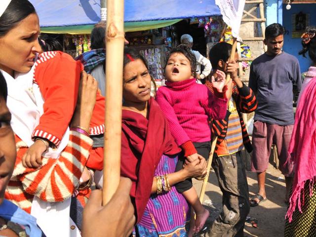 Mentally-challenged Kirti, 4, is carried by her mother as she attends a rally organised on World Disabled Day to create awareness on disability issues at a slum in Govindpuri area of Delhi. (Saumya Khandelwal/HT Photo)