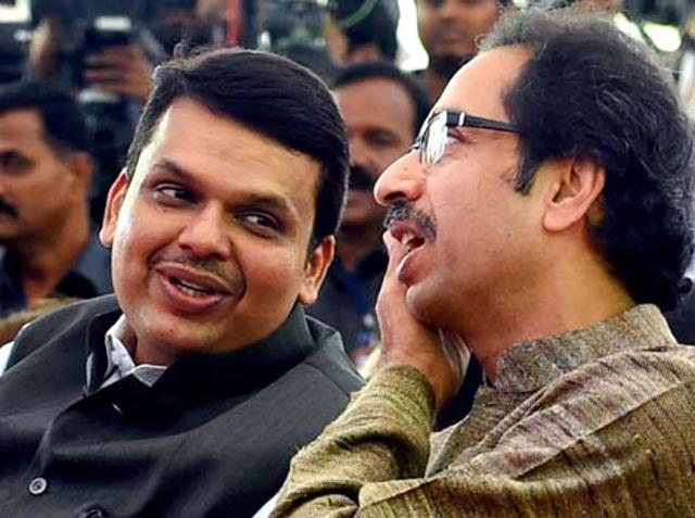 Maharashtra CM Devendra Fadnavis along with Shiv Sena chief Uddhav Thackeray during the swearing-in ceremony for the new ministers from Sena in Mumbai. (PTI photo)