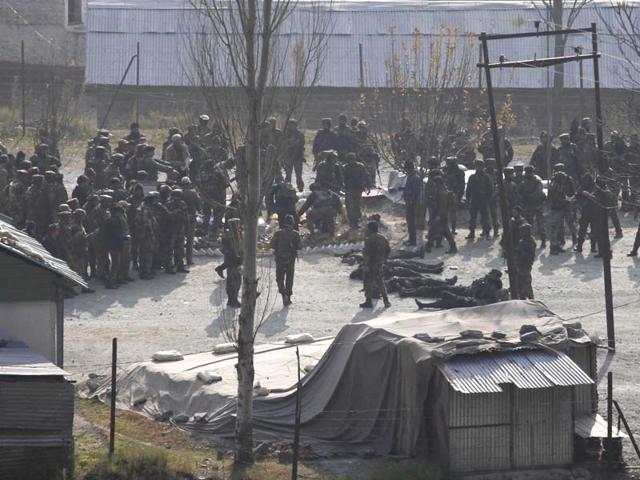 Army soldiers stand near the bodies of militants killed in encounter, at Gingal village in Uri Tehsil of Baramula district, in Jammu and Kashmir. (Waseem Andrabi/HT Photo)