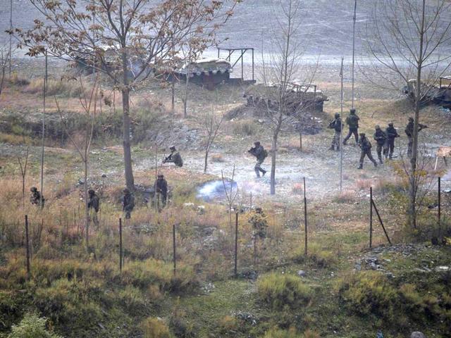 Indian Army personnel search for suspected militants as smoke rises from a bunker after a gun battle in Uri on Friday. (Reuters)