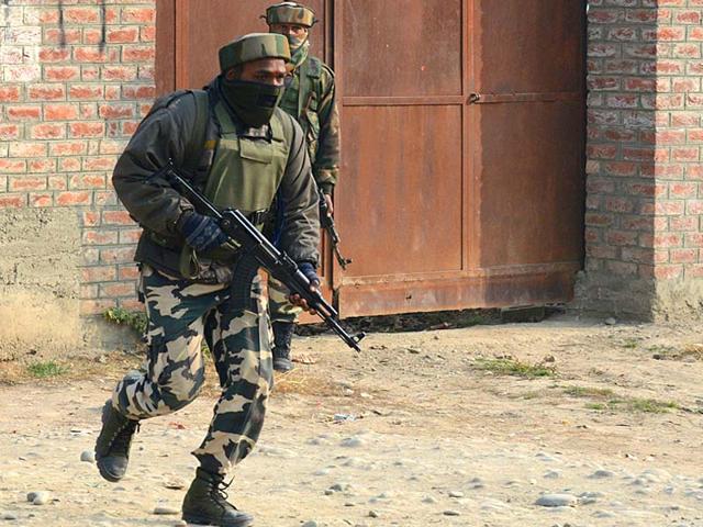 Indian soldiers take positions during a gunfight with militants on the outskirts of Srinagar. (AFP Photo)