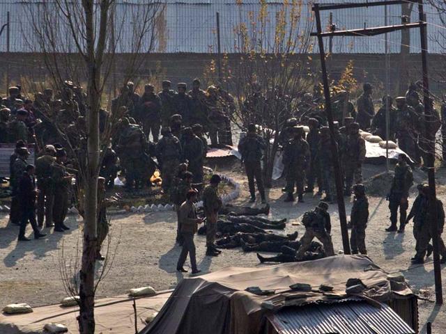 Indian army soldiers stand near bodies of alleged suspected militants killed in a gun battle in Gingal. (AP Photo)