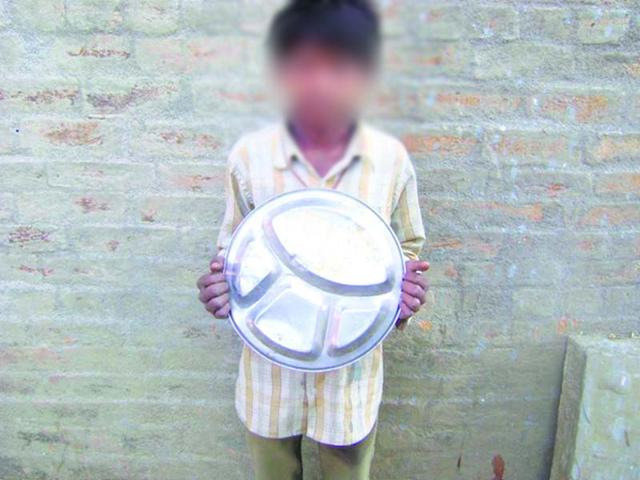 A-Dalit-child-shows-a-plate-marked-by-his-name-used-for-distribution-of-mid-day-meal-in-a-school-in-Sehore-district-HT-photo