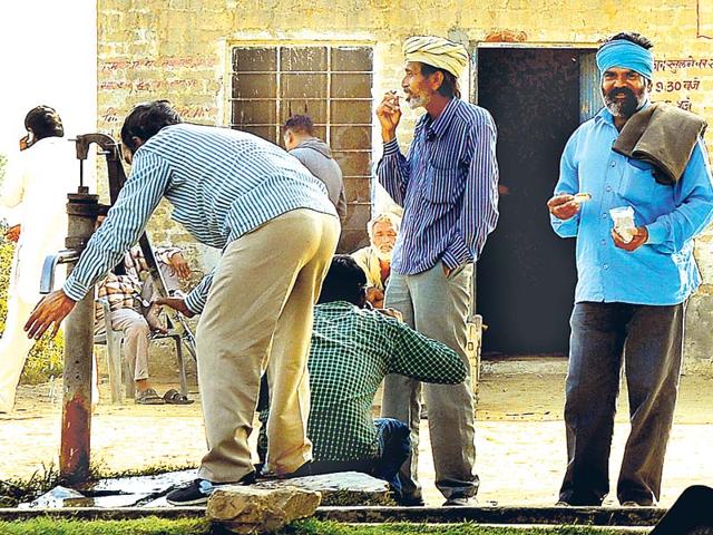 Customers-outside-a-doda-post-shop-at-Hindumalkot-in-Ganganagar-district-Prabhakar-Sharma-HT-Photo