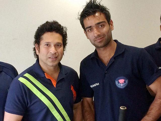 Sachin Tendulkar meets a member of the Jammu and Kashmir team that defeated 40-time champion Mumbai in a Ranji Match, in Mumbai. (PTI photo)