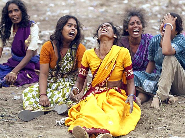 Indian women mourn the death of their families killed in the tsunami in Madras, in December 2004. (Reuters)