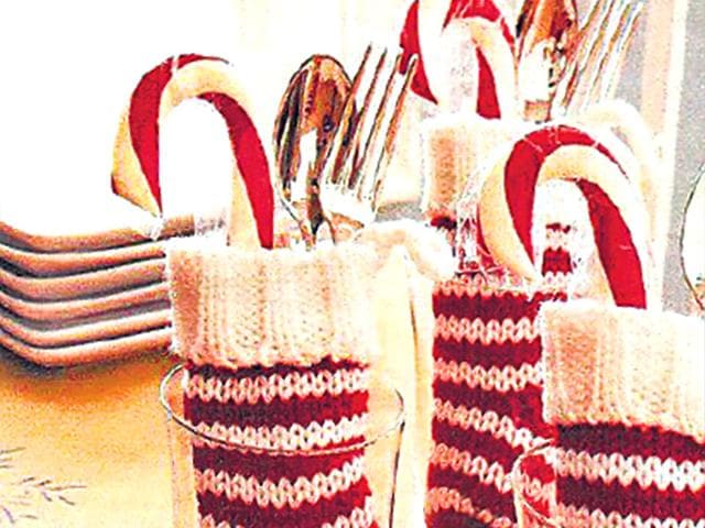 December brings with it the whiff of festivities. To bring a celebratory vibe to the table, here are fun ways to perk up your dining accomplices. (Text by: Snigdha Ahuja) Dressing up your silver: Get boredome off the table and throw some colour and fun onto it! Snuggle your silver inside empty glass jars filled with scented dinner napkins. But, for an all-out festive spirit, look nothing beyond this Santa-red stocking and candy cane combo to hold all your silver.