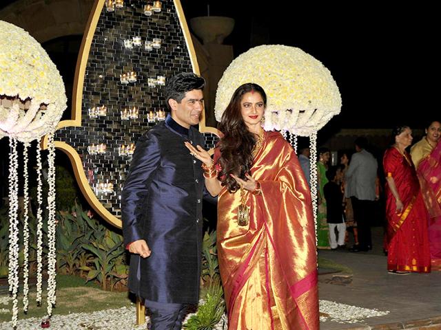 Ace designer Manish Malhotra made sure that Bollywood celebrities attend his niece Rriddhi Malhotra's wedding reception. Here he is seen with Rekha. (Photo: Prodip Guha)
