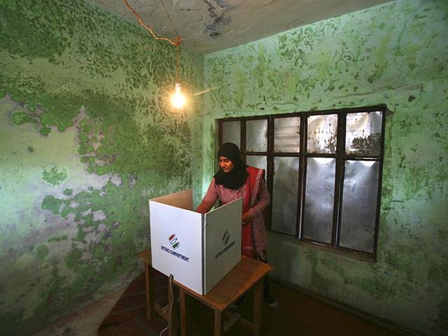 A woman casts her vote at a polling station during the fifth and last phase of the Jammu and Kashmir state assembly elections on the outskirts of Jammu. (Reuters)