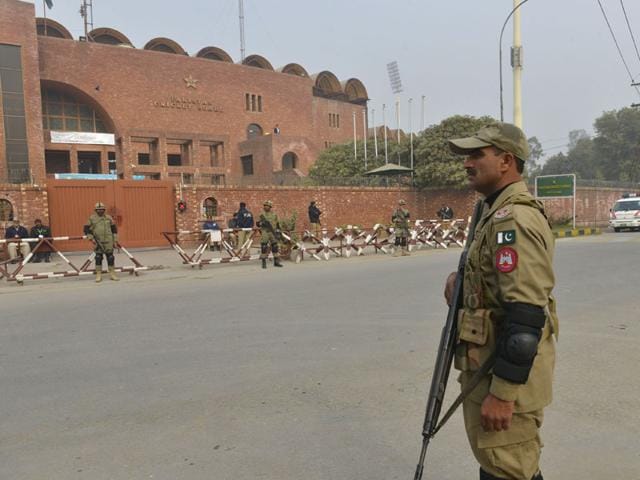 A-plainclothes-security-officer-escorts-students-evacuated-from-a-nearby-school-after-the-Taliban-attack-on-Army-Public-School-in-Peshawar-Pakistan-AP-Photo A-plainclothes-security-officer-escorts-students-evacuated-from-a-nearby-school-after-the-Taliban-attack-on-Army-Public-School-in-Peshawar-Pakistan-AP-Photo