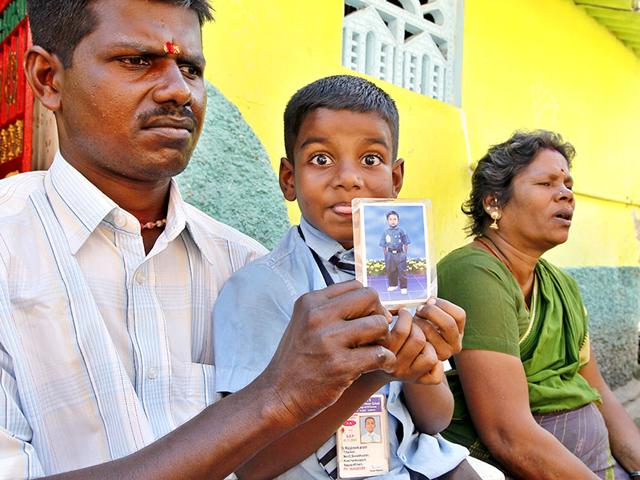 T-Shankar-left-and-Chintamani-sit-with-their-son-Rajshekara-holding-a-photo-of-their-deceased-son-Paneersilvam-during-an-interview-with-HT-in-Nagapattinam-Tamil-Nadu-HT-Photo-Gurinder-Osan