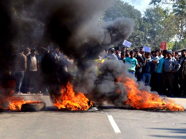 Activists-of-the-Assam-Tea-Tribes-Student-Association-ATTSA-block-the-NH-52-road-with-burning-tyres-during-a-protest-against-the-attacks-on-villagers-in-Assam-AFP-Photo Activists-of-the-Assam-Tea-Tribes-Student-Association-ATTSA-block-the-NH-52-road-with-burning-tyres-during-a-protest-against-the-attacks-on-villagers-in-Assam-AFP-Photo
