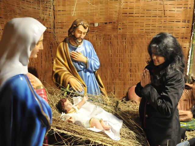 A girl offers prayer at Asha Niketan church on the occasion of Christmas in Bhopal on Thursday. (Mujeeb Frauqui/HT photo)