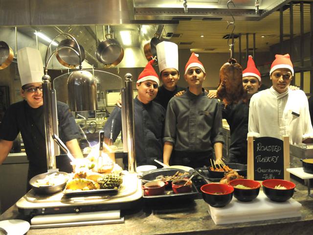 Chefs present the lavish Christmas special food for Bhopalis at MoMo Café on Wednesday evening. (Mujeeb Frauqui/HT photo)