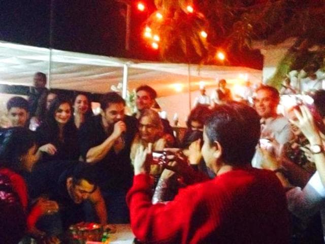 Salman Khan cuts his birthday cake surrounded by friends and family at his farmhouse in Panvel. (Courtesy: Twitter)
