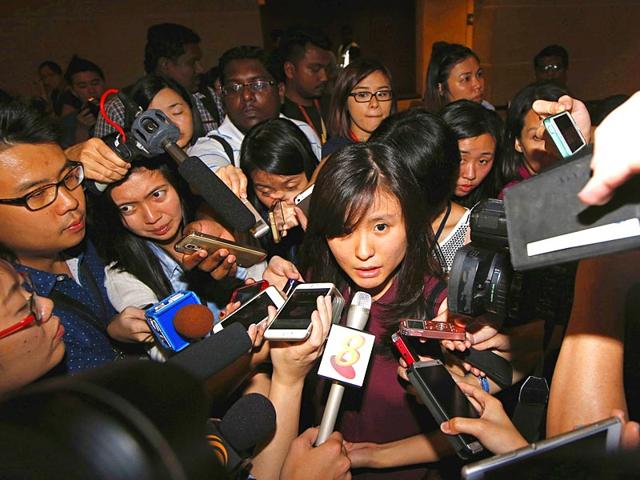 Louis Sidharta (C), a 25-year-old Indonesian whose fiance was onboard the AirAsia flight QZ8501, speaks to the media at a waiting area for next-of-kin and relatives at Changi Airport in Singapore. (Reuters)
