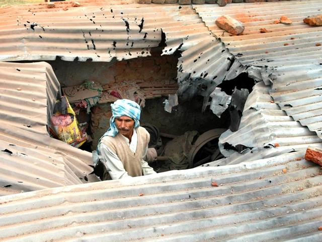 A villager inspects the roof of his house allegedly damaged in shelling from the Pakistani side, in the Samba sector. (Nitin Kanotra/HT Photo) A villager inspects the roof of his house allegedly damaged in shelling from the Pakistani side, in the Samba sector. (Nitin Kanotra/HT Photo)