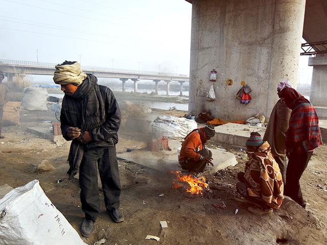 Winters are particularly the harshest of months for the homeless in the capital, especially if one finds refuge near the river Yamuna. People migrate here looking for a livelihood but end up jobless competing for limited resources while a constant migration puts a strain on the capital's shrinking space. (Subrata Biswas/HT Photo)
