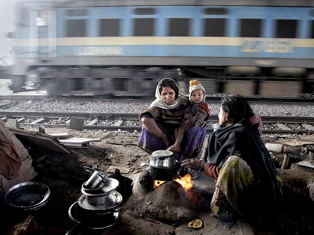Arti, 45, a rag picker with her daughter-in-law Kanika (20) in their makeshift-home put up beside railway tracks near Okhla station in Delhi. She migrated with her family from Akbarpur, UP to Delhi around 25 years ago. Arti, like many others who migrated here for a better living, make the city function in the day but spend their nights without a proper shelter. (Subrata Biswas/HT Photo)