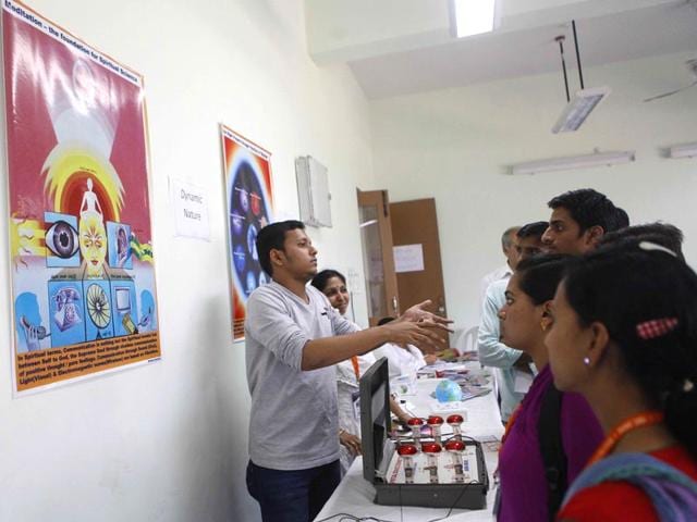 People at an exhibition on spiritual science at the Shankar Rao Chavan Academy in Kalina University during 102nd Indian Science Congress in Mumbai. (Pratham Gokhale/HT photo)