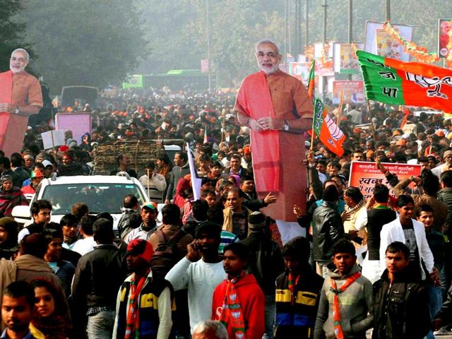 Supporters carry huge cut-outs of Prime Minister Narendra Modi after BJP's 'Abhinandan' rally at the Ramlila Maidan in New Delhi. (PTI photo)