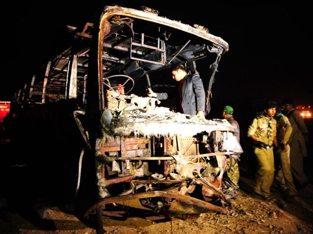 Volunteers-search-for-victims-inside-a-burnt-out-passenger-bus-after-it-collided-with-an-oil-tanker-along-the-Super-Highway-near-Karachi-AFP-Photo Volunteers-search-for-victims-inside-a-burnt-out-passenger-bus-after-it-collided-with-an-oil-tanker-along-the-Super-Highway-near-Karachi-AFP-Photo