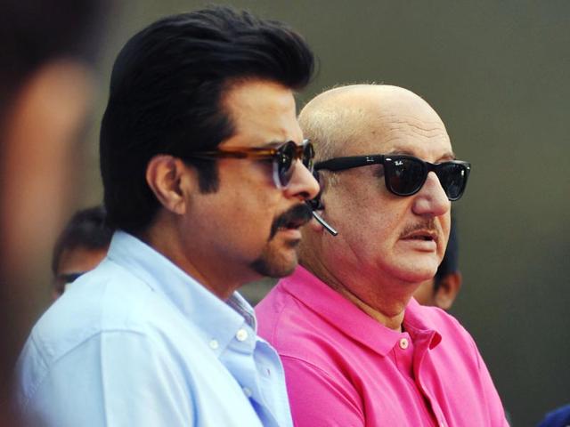 Anil Kapoor and Anupam Kher watch the first match of Celebrity Cricket League (CCL) season five in Mumbai on January 10, 2015. (AFP Photo)