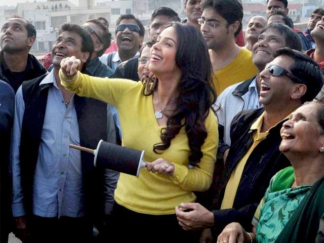 Bollywood actor Mallika Sherawat enjoying kite fly on the occasion of Makar Sakranti in Jaipur on Wedesday. (PTI Photo)