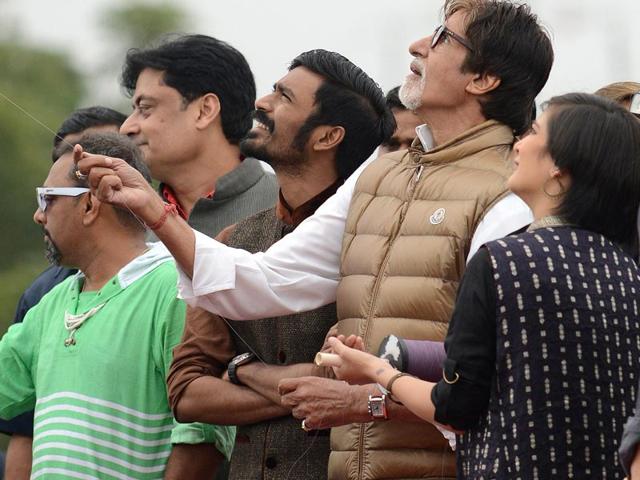 Amitabh Bachchan flies a kite assisted by Akshra Hasan and Dhanush in Ahmedabad on the occasion of Uttarayan. Bachchan was in Ahmedabad for promotion of Shamitabh. (AFP)