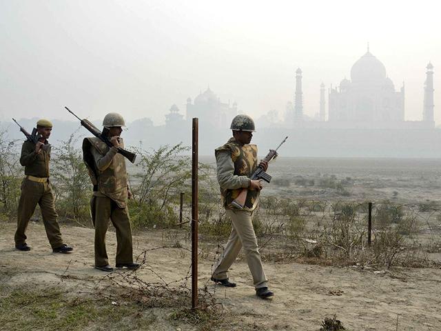 Security personnel patrol on the rear side of the Taj Mahal, on a foggy winter day in Agra. (Reuters)