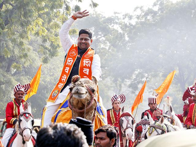 Shiv Sena candidate Shiv Kumar Tiwari (on camel) on his way to file his nomination at Jam Nagar House for Delhi Assembly elections, in New Delhi. (Ajay Aggarwal/HT Photo)
