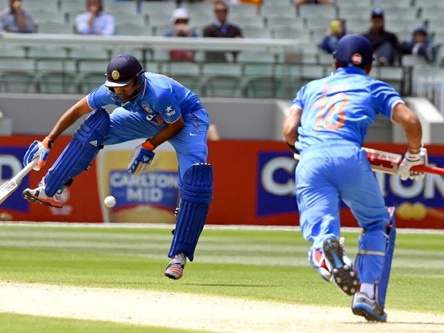 India's Rohit Sharma, left, jumps over the ball hit from team mate Virat Kohli, right, during their One Day International cricket match against Australia in Melbourne. (AP photo)
