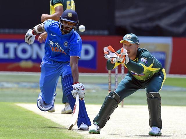 India's Shikhar Dhawan, left, avoids a run out as Australia's Brad Haddin, right, fields the ball during their one-day international cricket match in Melbourne, Australia . (AP photo)