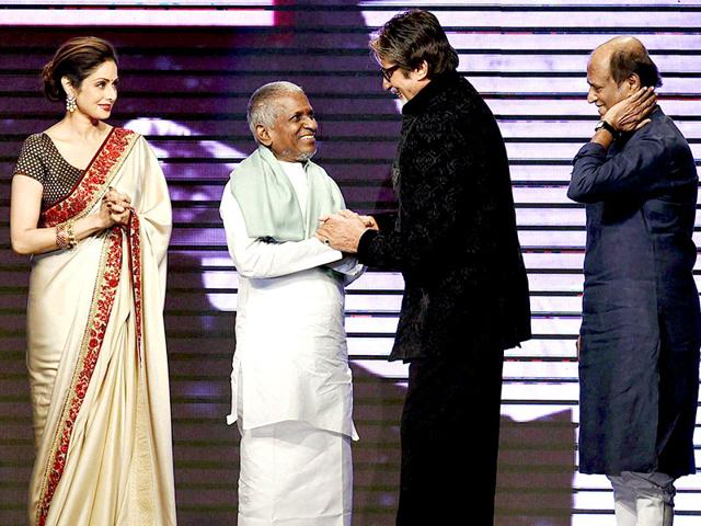 Amitabh Bachchan felicitates music director Ilaiyaraaja as Sridevi, Rajinikanth and Kamal Haasan look on during the music launch of Shamitabh in Mumbai on January 20, 2015. Shamitabh is Ilaiyaraaja's 1000th movie. (AFP Photo) Amitabh Bachchan felicitates music director Ilaiyaraaja as Sridevi, Rajinikanth and Kamal Haasan look on during the music launch of Shamitabh in Mumbai on January 20, 2015. Shamitabh is Ilaiyaraaja's 1000th movie. (AFP Photo)