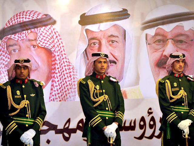 Saudi-royal-guards-stand-on-duty-in-front-of-portraits-of-King-Abdullah-bin-Abdulaziz-R-Crown-Prince-Salman-bin-Abdulaziz-C-and-second-deputy-Prime-Minister-Muqrin-bin-Abdulaziz Saudi-royal-guards-stand-on-duty-in-front-of-portraits-of-King-Abdullah-bin-Abdulaziz-R-Crown-Prince-Salman-bin-Abdulaziz-C-and-second-deputy-Prime-Minister-Muqrin-bin-Abdulaziz