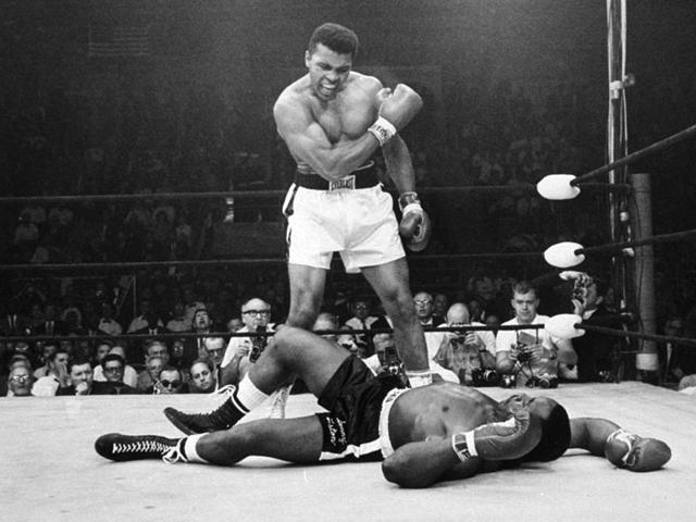 In this May 25, 1965, photo, Muhammad Ali stands over Sonny Liston shortly after dropping him less than two minutes into the first round of their heavyweight title fight, in Lewiston, Maine. Just months before the 50th anniversary of the fight, which remains one of the most controversial sporting events of the 20th century, both pairs of gloves are going on the auction block for the first time. (Text and Photo: AP) In this May 25, 1965, photo, Muhammad Ali stands over Sonny Liston shortly after dropping him less than two minutes into the first round of their heavyweight title fight, in Lewiston, Maine. Just months before the 50th anniversary of the fight, which remains one of the most controversial sporting events of the 20th century, both pairs of gloves are going on the auction block for the first time. (Text and Photo: AP)