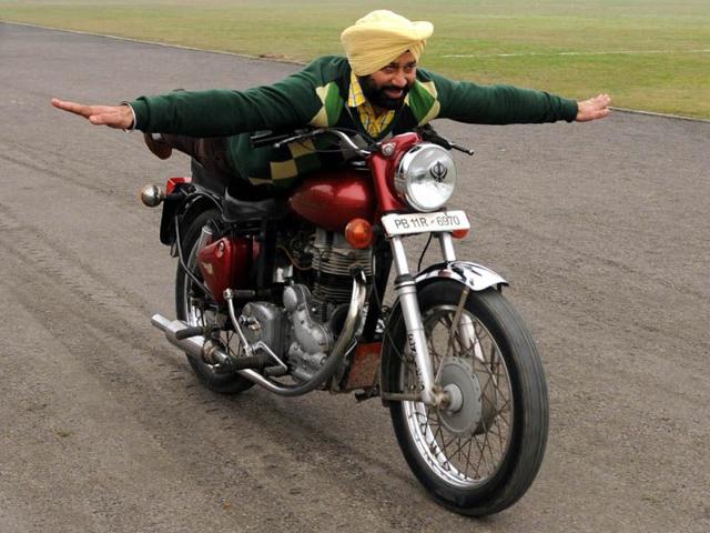 Stuntman performing stunt on Bullet motorcycle during rehearsal for the Republic Day at YPS Stadium in Patiala on Sunday. Bharat Bhushan/HT