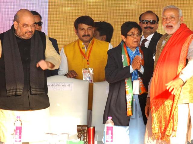 Prime Minister Narendra Modi with BJP's Delhi chief ministerial candidate Kiran Bedi and BJP president Amit Shah at an election rally in Karkardooma in New Delhi. (Mohd Zakir/HT Photo)