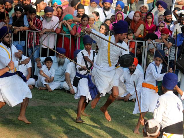 Young Sikhs exhibit martial skills on the concluding day of a three-day religious meet in Indore on Sunday. (Shankar Mourya/HT photo)