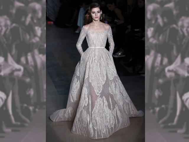 A sheer off-the-shoulder "princess" gown by Lebanese couturier to the stars, Elie Saab, featuring a dreamy tulle skirt embellished with stunning tulip embroidery