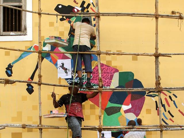 Artists give finishing touch to a graffiti ahead of the Hindustan Times Kala Ghoda Arts Festival 2015 near Kala Ghoda chowk in Mumbai. (Arijit Sen/HT Photo)