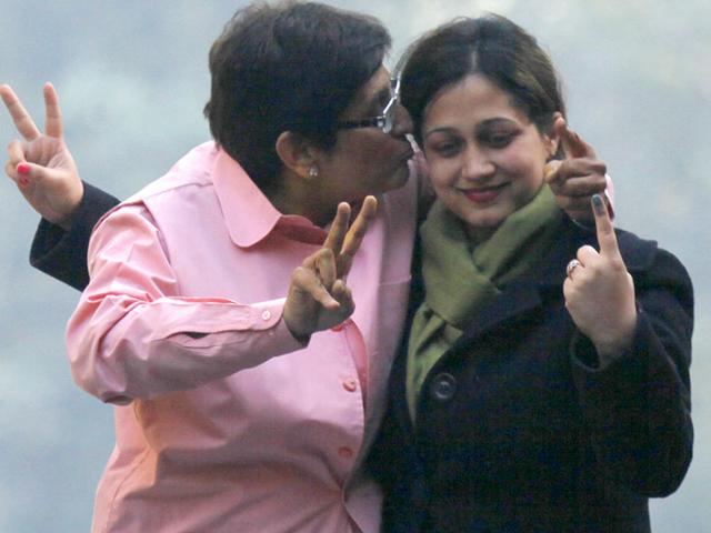 BJP chief ministerial candidate Kiran Bedi stands on the top of a car and kisses a supporter after casting her vote in the Delhi assembly elections. (HT Photo/ Raj K Raj)