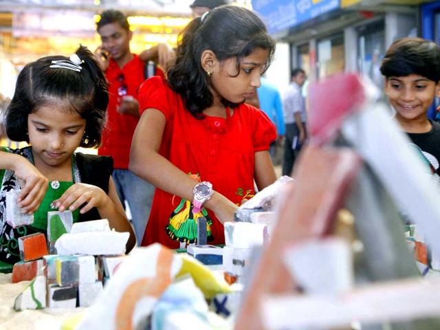 Kids watch Artist Soazic Guezennec's art installations at Chhatrapati Shivaji Terminus railway station at the ongoing Kala Ghoda Festival in Mumbai. (Pratham Gokhale/HT photo)